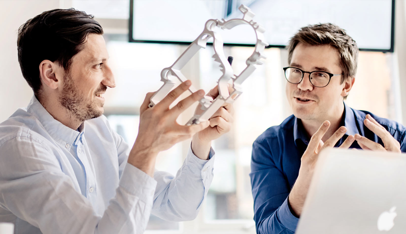 a person showing a person something on the computer