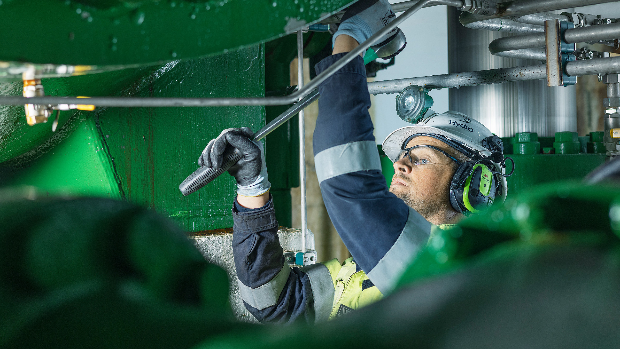 a person wearing a helmet and goggles working on a bar