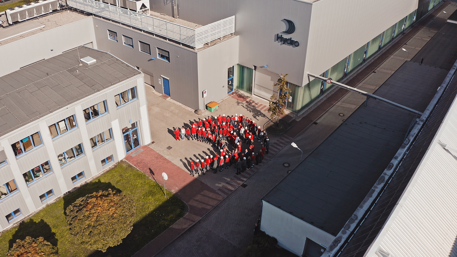 a group of people standing in a circle outside a building