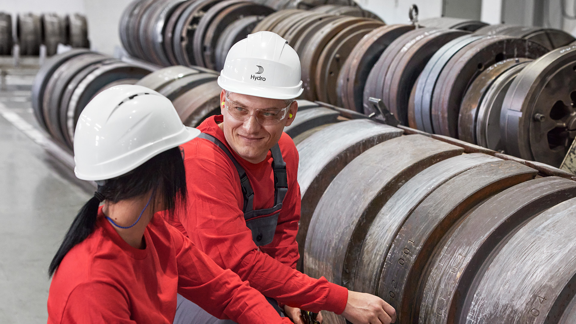 a man and woman wearing hard hats
