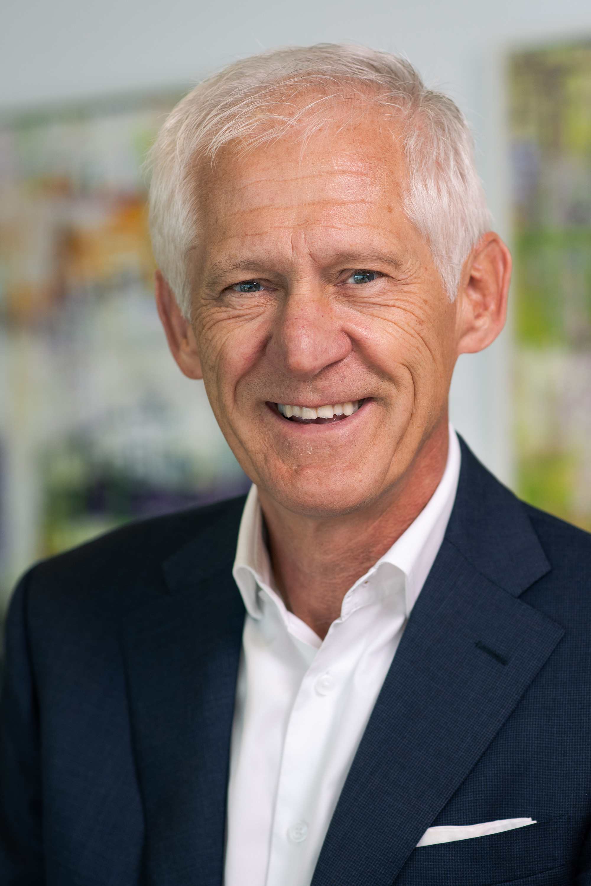 a man in a suit smiling