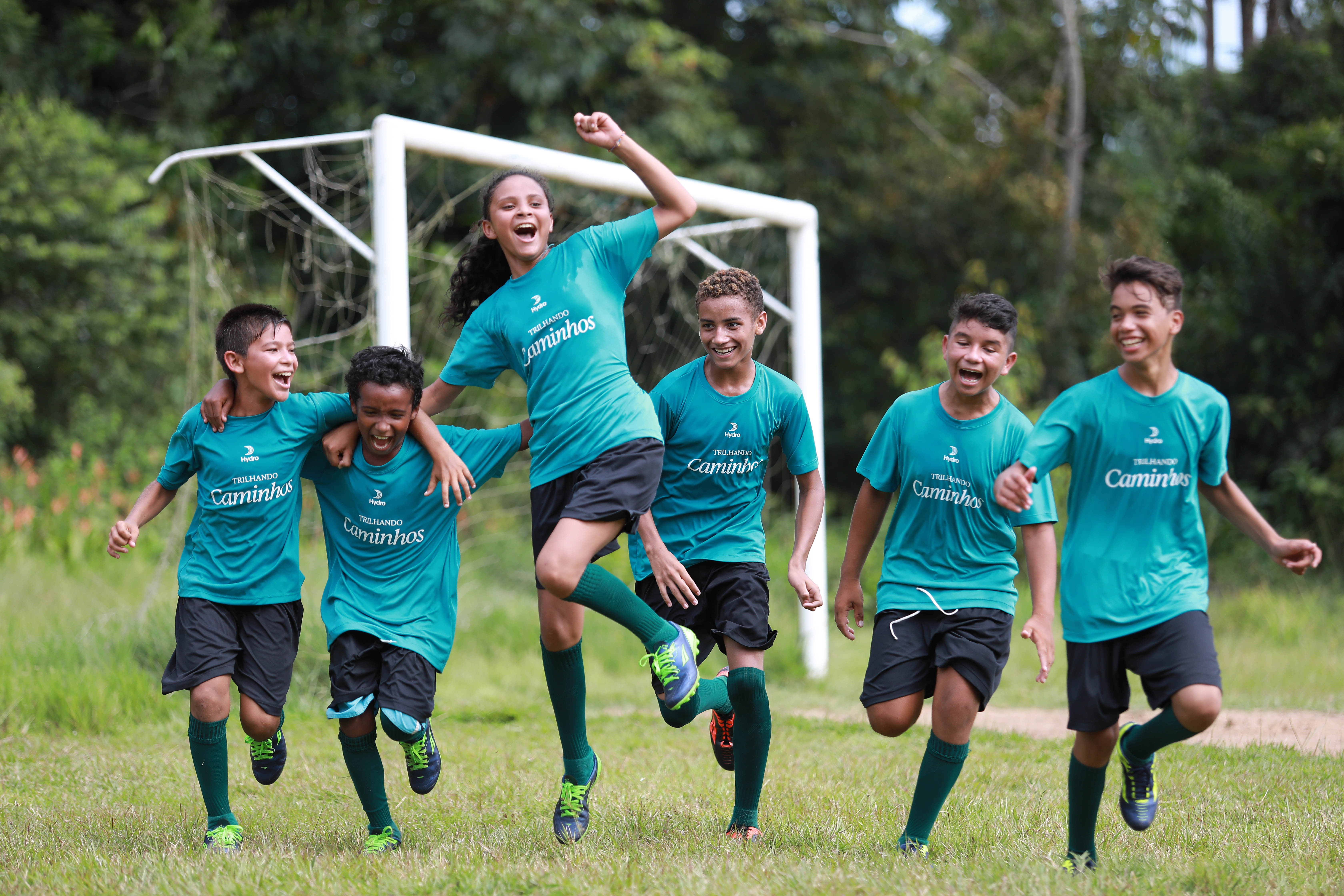 a group of men running on a field