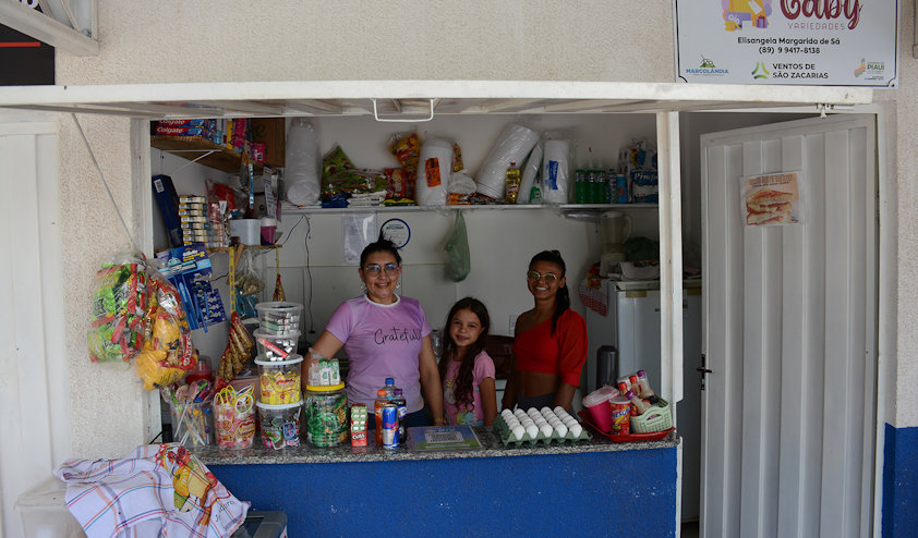 a group of people posing for a photo in a kitchen
