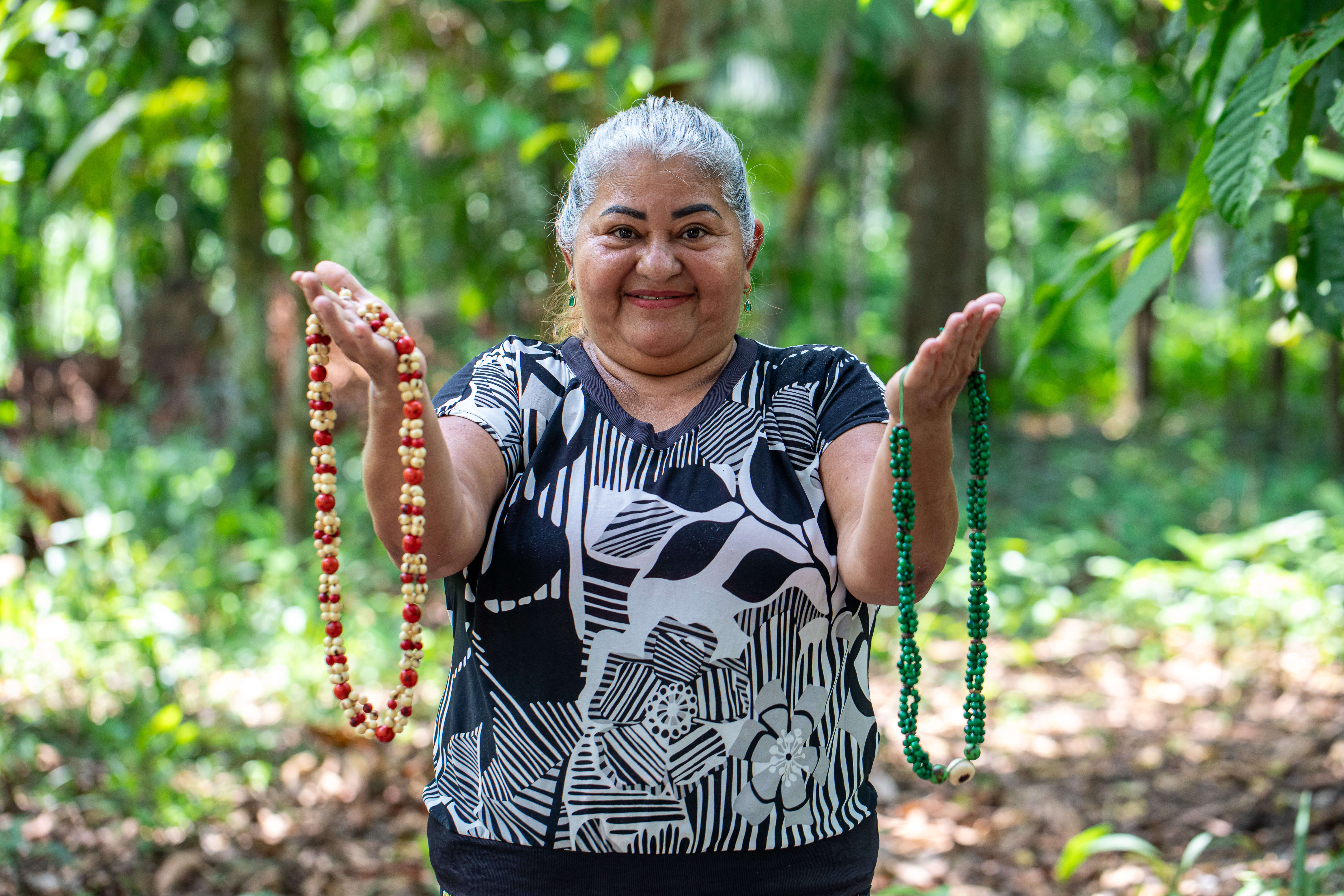 a woman holding necklaces in her hands
