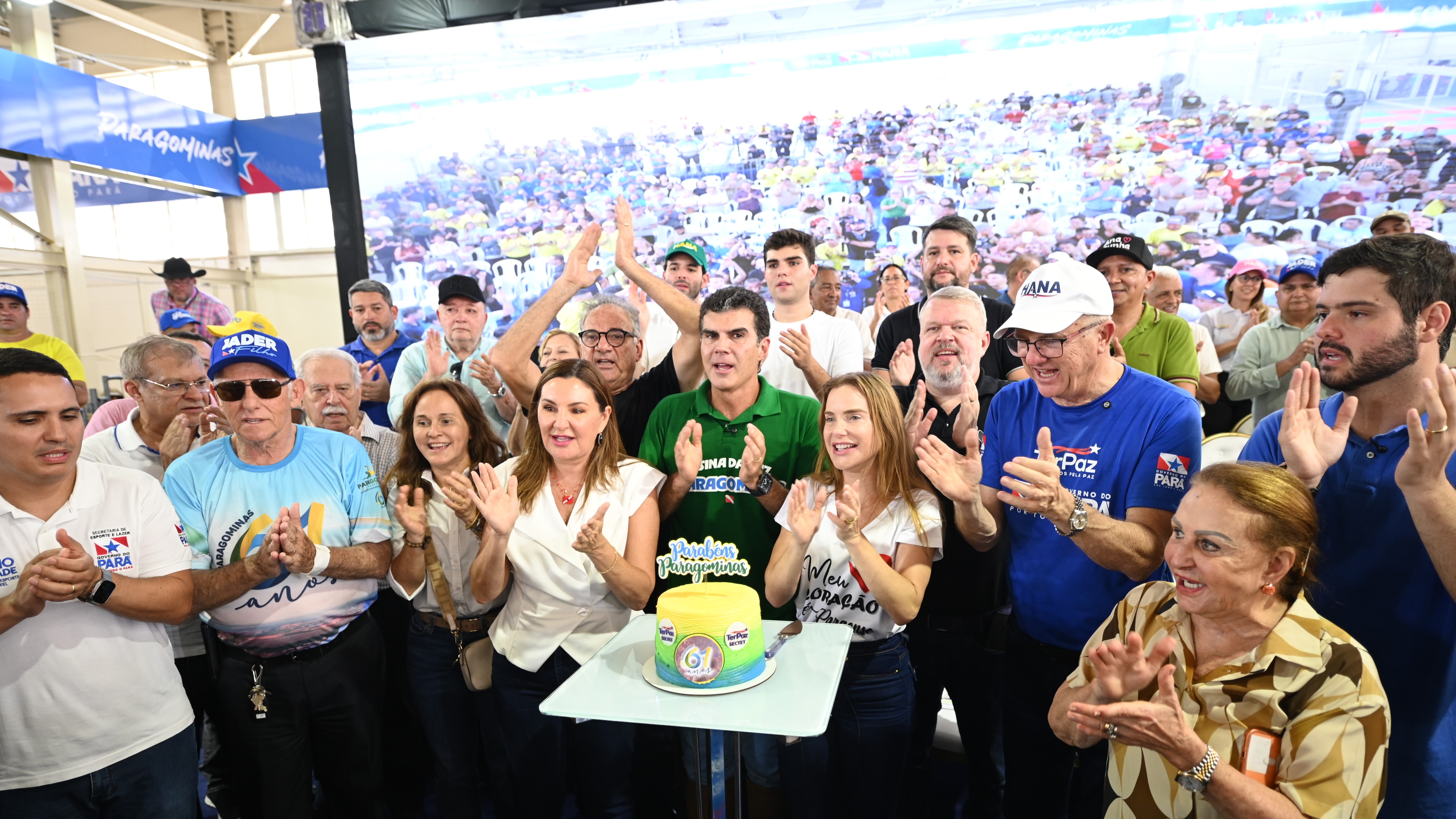 a group of people standing around a cake