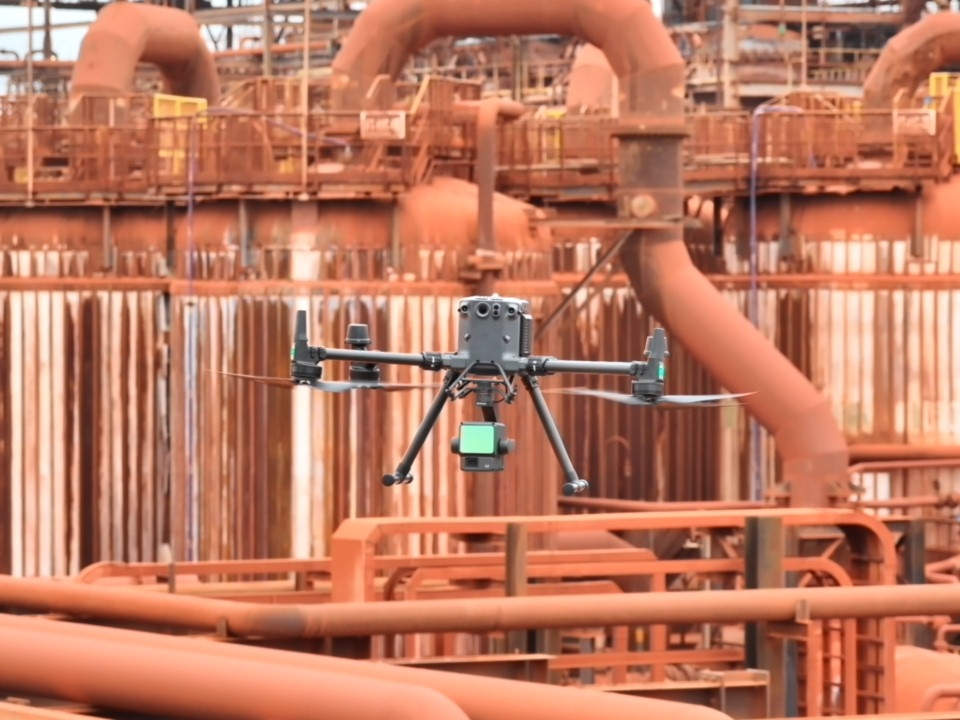 a drone flying over a factory