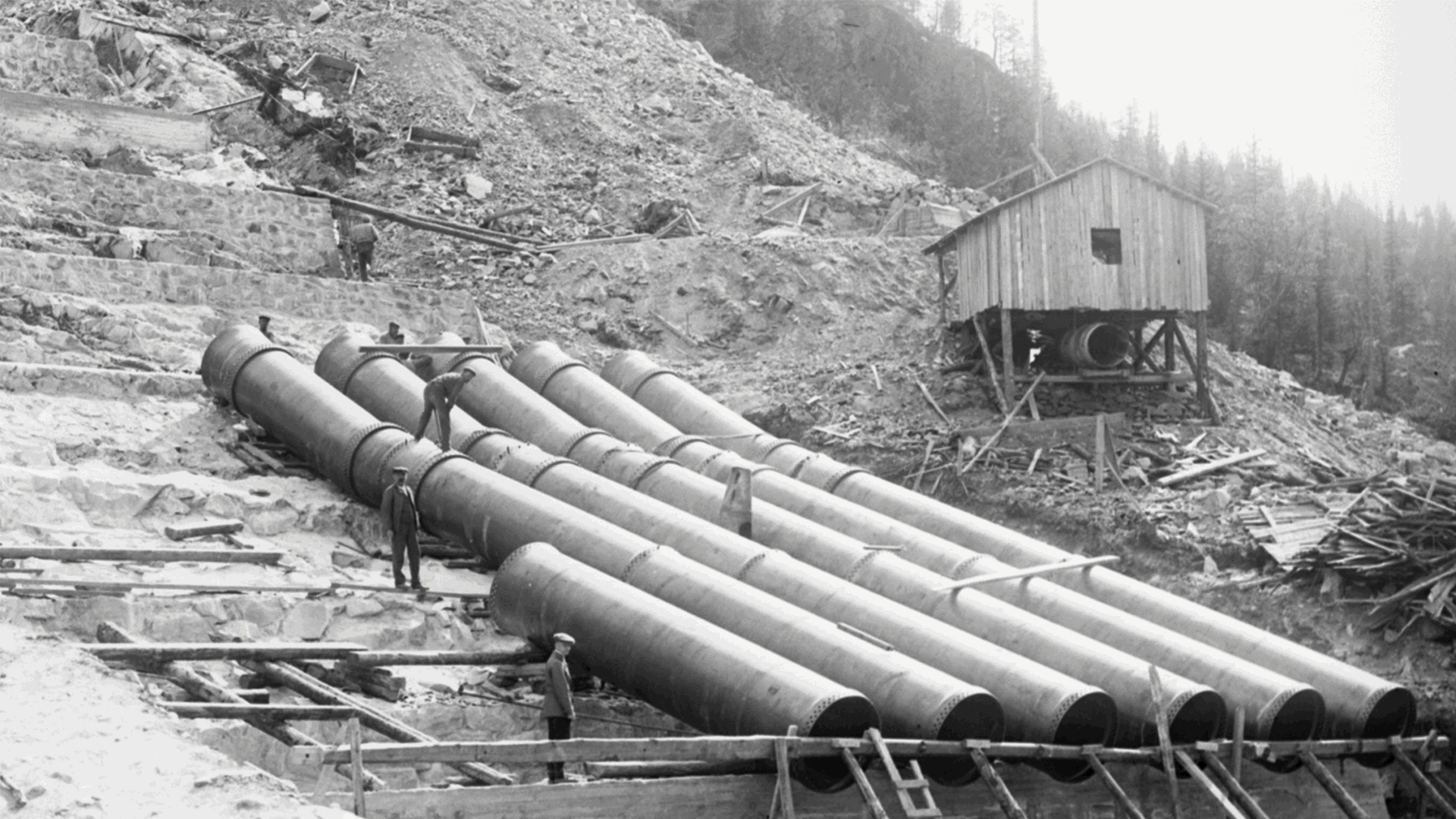 a person standing next to a large pipe