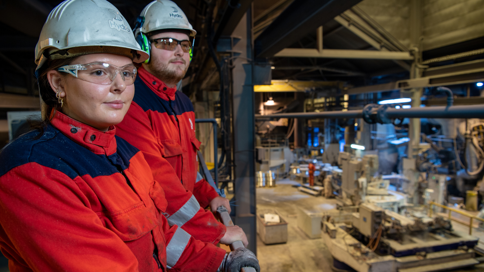 a man and woman wearing hard hats